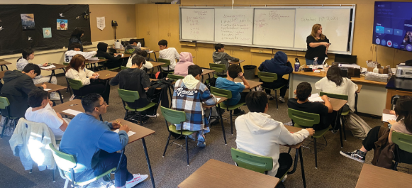 Dena Chavez begins a lecture for her students in classroom F-10. The students had just finished a test.