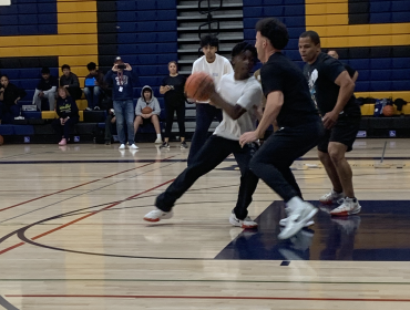 Staff stand victorious in basketball game against students